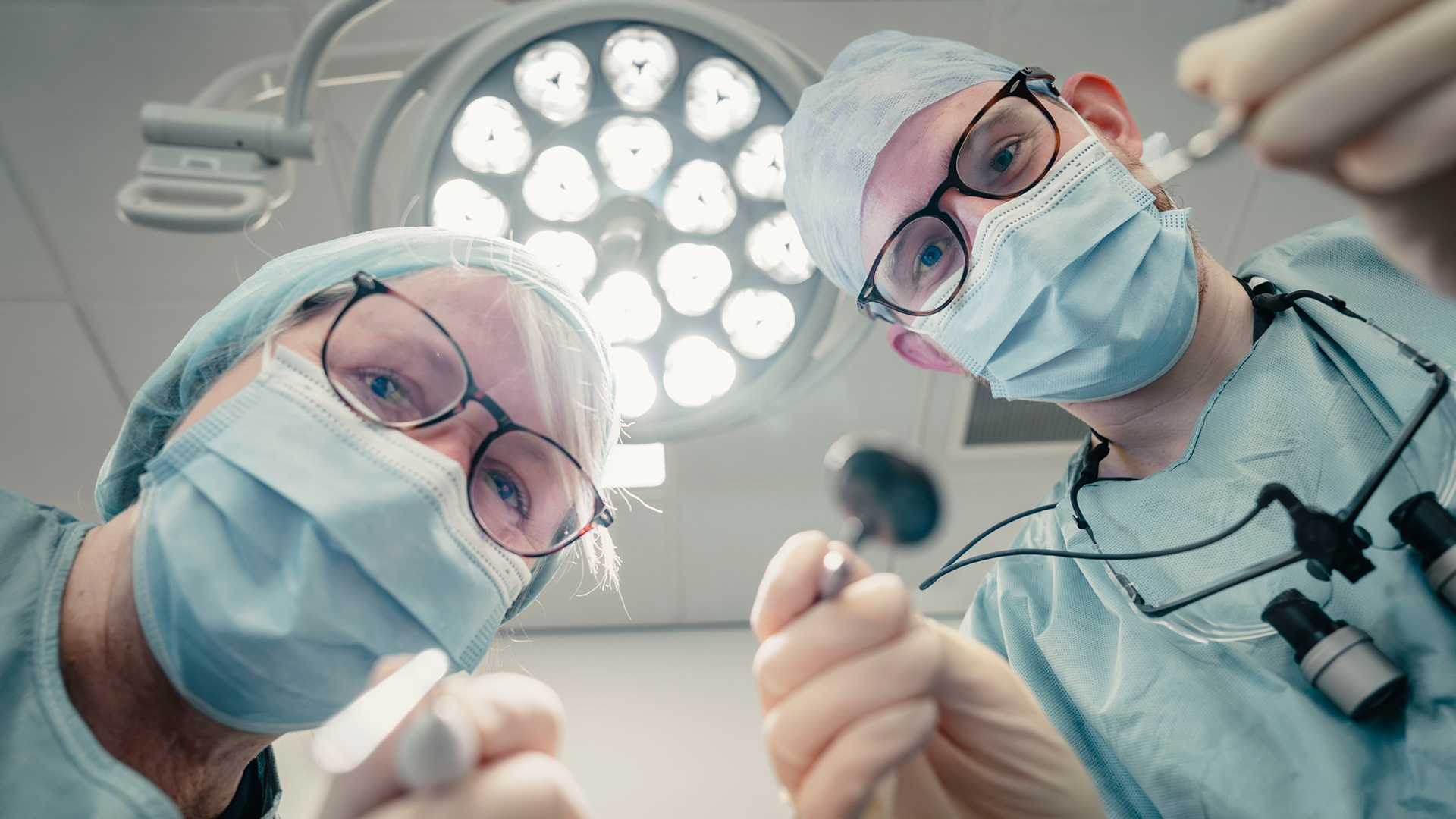 Dentist looking down onto a patient in the dental chair